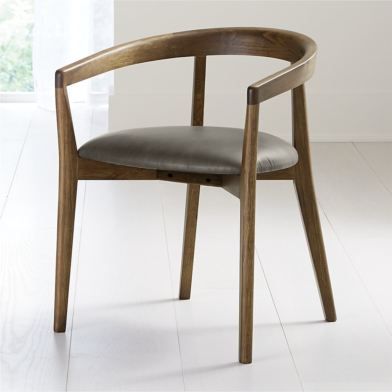 Cullen Shiitake Stone Round Back Dining Chair. Using remarkable joinery techniques, skilled woodworkers expertly fit sections of solid chestnut wood to fashion Cullen's Scandinavian modern curves