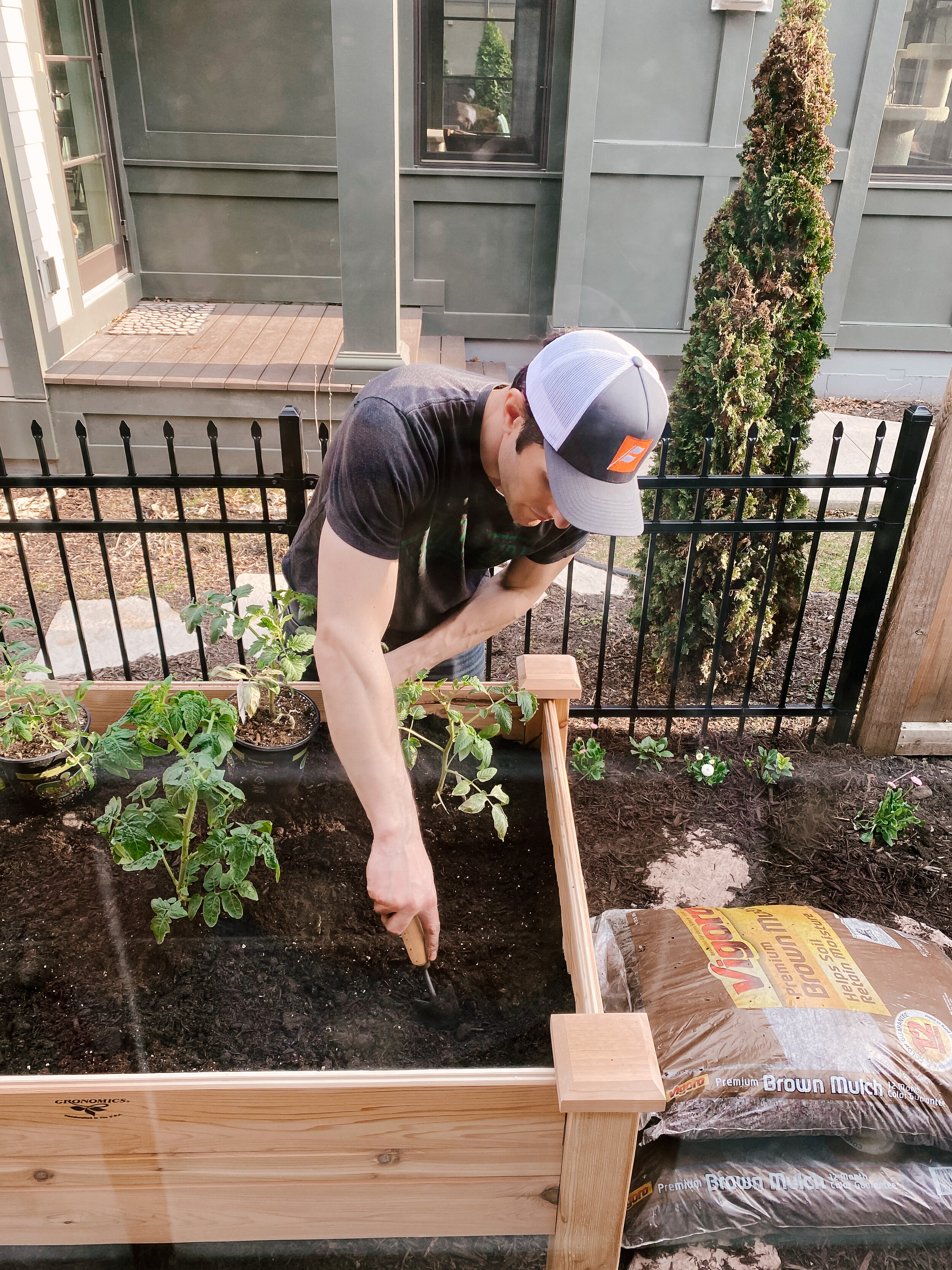 Brian planting the vegetables in the raised garden bed.