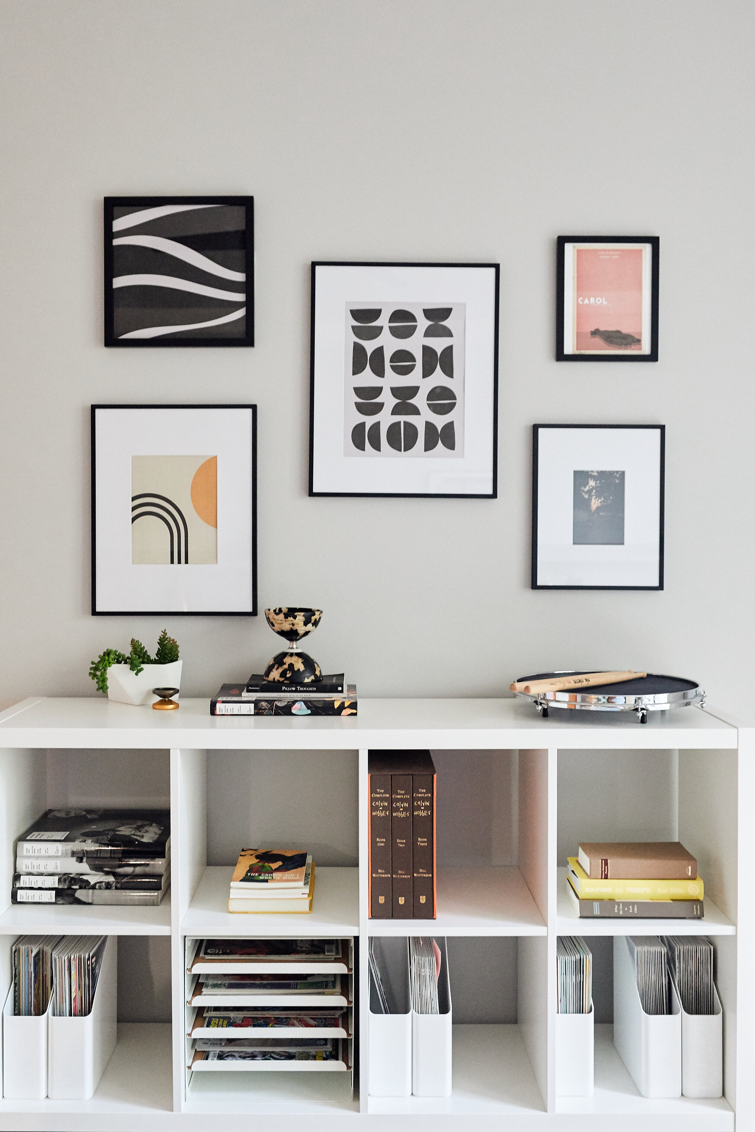 Photo by Canary Gray for HGTV. Sources: metal furniture legs, picture frames, Etsy downloadable art coral pink carol print, neutral abstract prints, and neutral geometric print