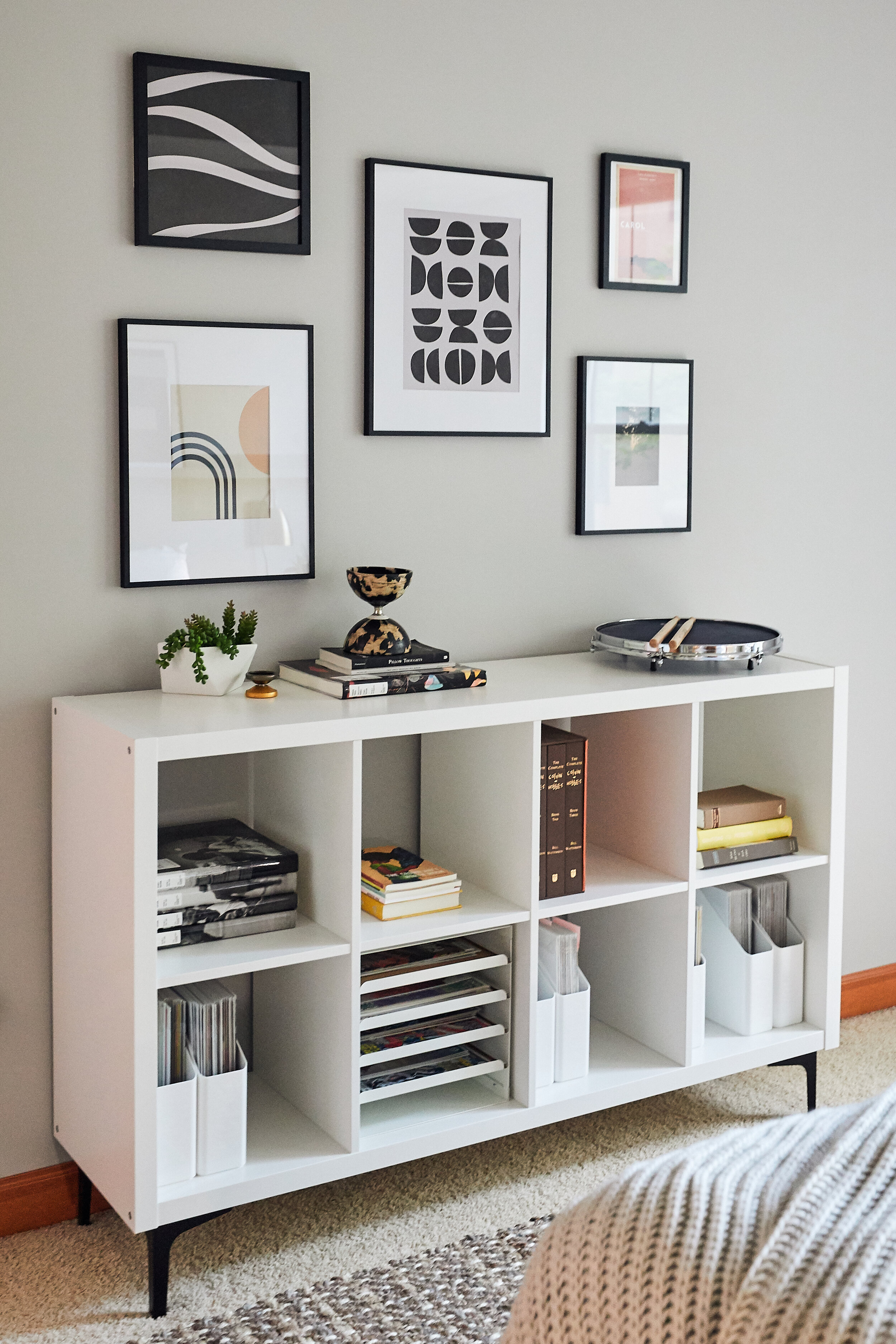 Photo by Canary Gray for HGTV. Sources: metal furniture legs, picture frames, Etsy downloadable art coral pink carol print, neutral abstract prints, and neutral geometric print