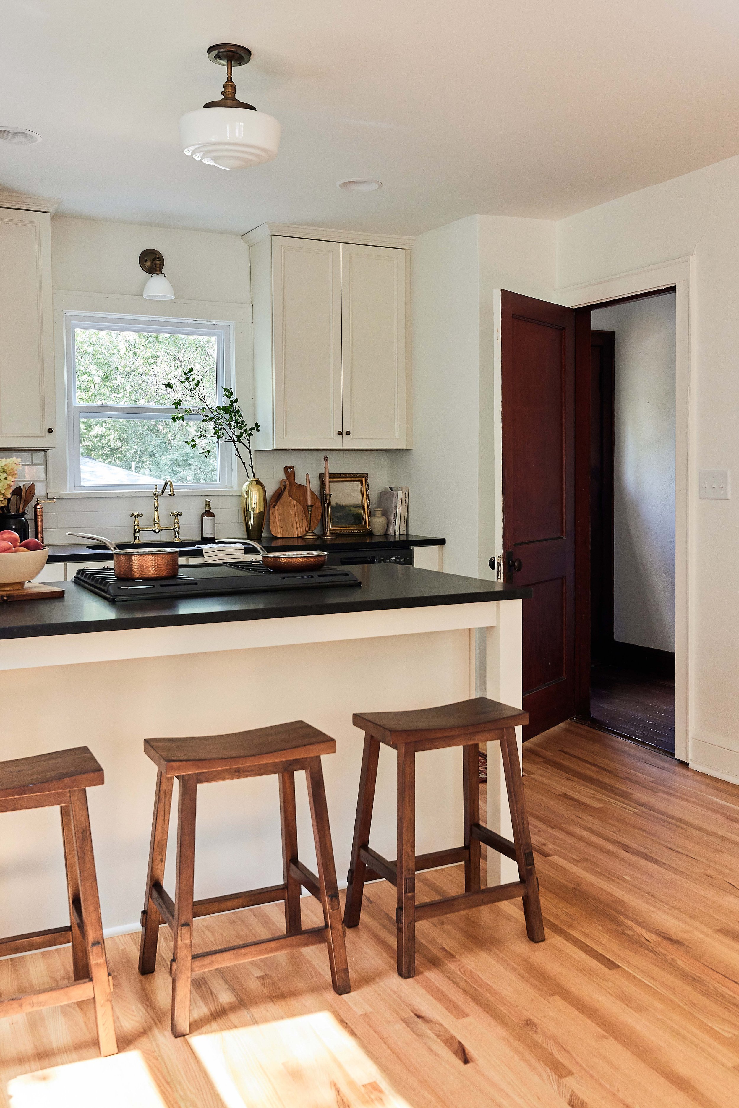 Our stucco farmhouse rental property renovation - kitchen layout & design reveal; cream cabinet with honed black granite kitchen