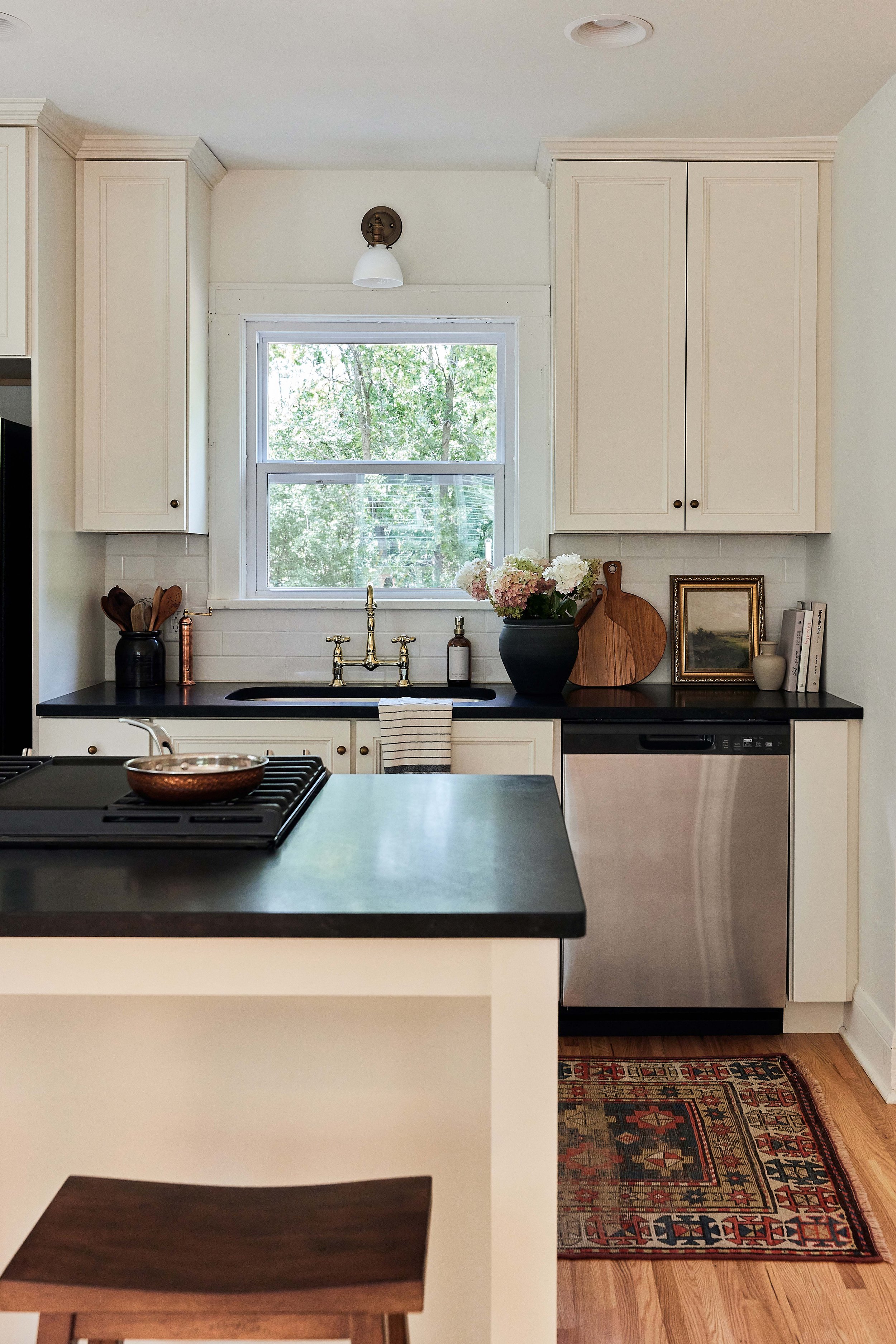 Our stucco farmhouse rental property renovation - kitchen layout & design reveal; cream cabinet with honed black granite kitchen