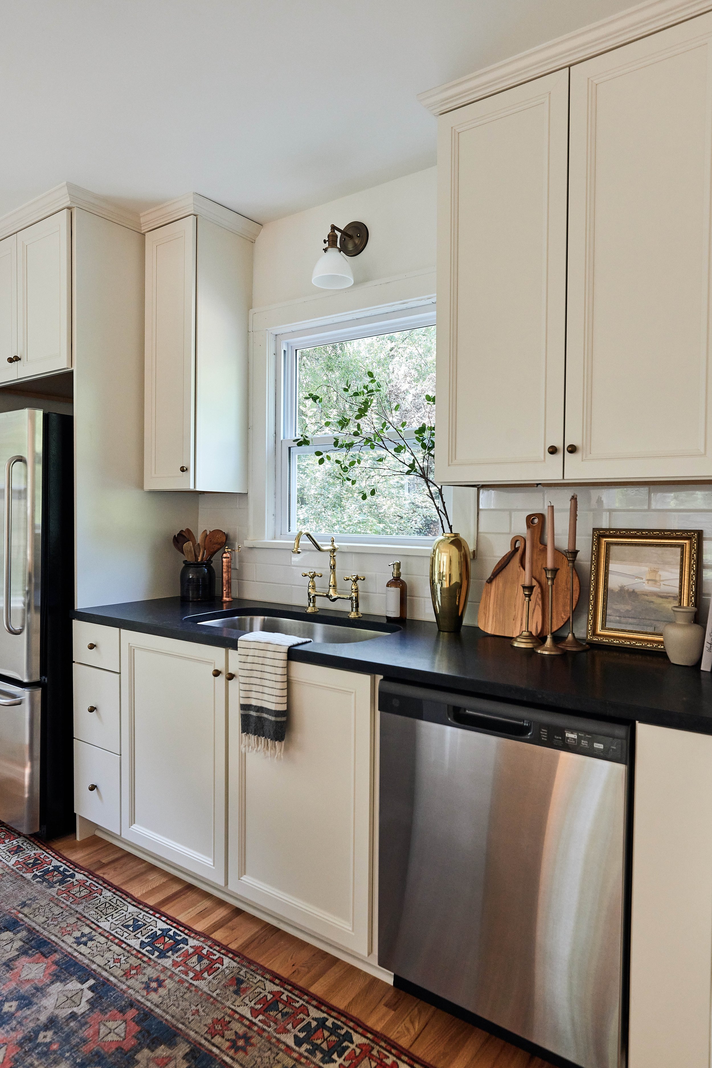 Our stucco farmhouse rental property renovation - kitchen layout & design reveal; cream cabinets and dark counters